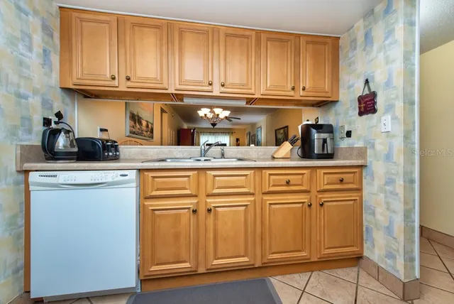 a kitchen with granite countertop cabinets and window