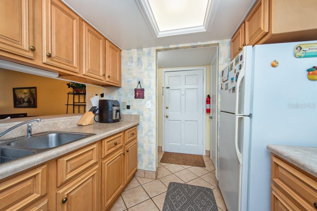 12760 Indian Rocks Road, Unit 601 Largo, FL 33774 - Photo 14 of 47 a kitchen with stainless steel appliances granite countertop a refrigerator and a sink