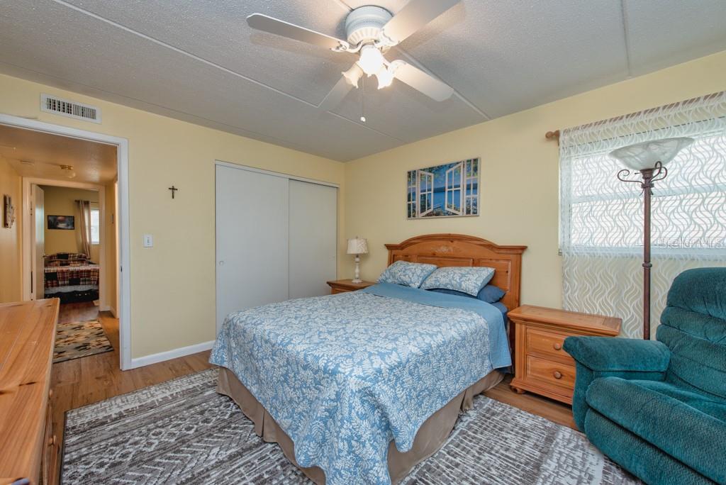 12760 Indian Rocks Road, Unit 601 Largo, FL 33774 - Photo 18 of 47 a bedroom with a bed and a couch