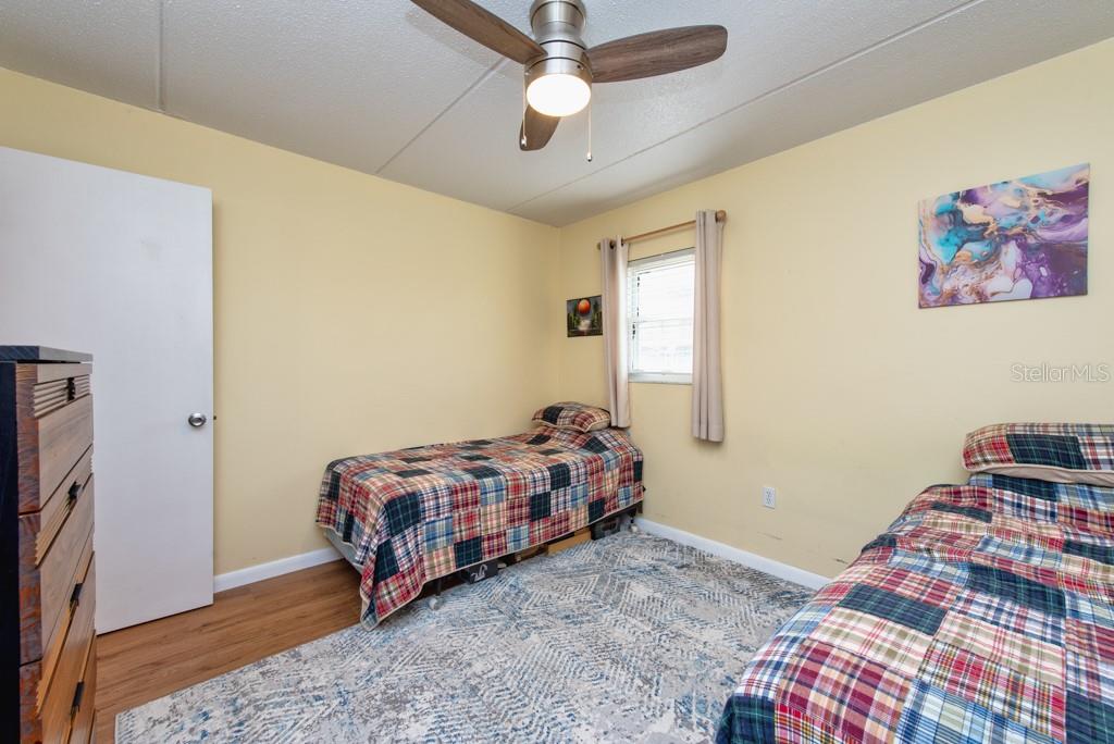 12760 Indian Rocks Road, Unit 601 Largo, FL 33774 - Photo 21 of 47 a bedroom with a bed and a chandelier