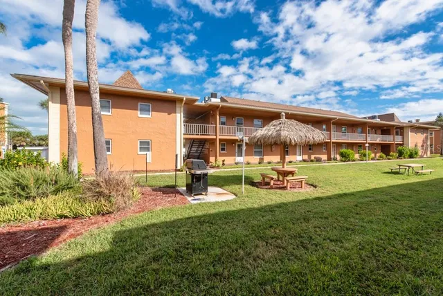 a front view of house with yard and trees