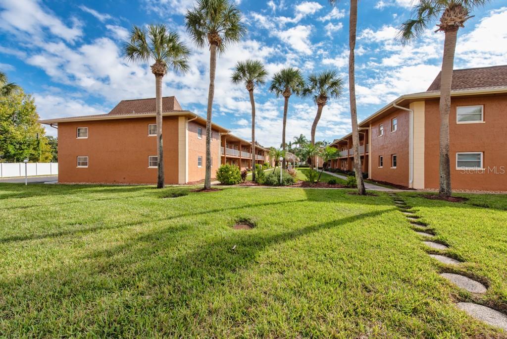 12760 Indian Rocks Road, Unit 601 Largo, FL 33774 - Photo 28 of 47 a front view of house with yard and trees