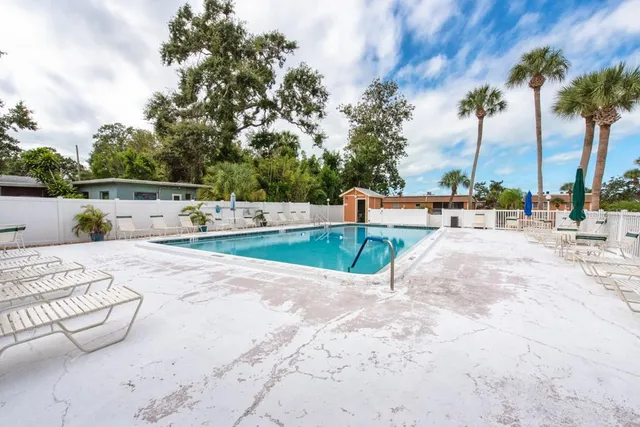 a view of building with swimming pool and sitting area