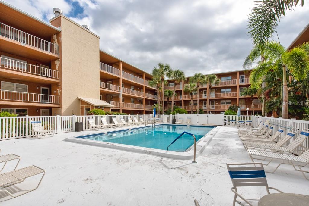12760 Indian Rocks Road, Unit 601 Largo, FL 33774 - Photo 33 of 47 a view of building with swimming pool and sitting area