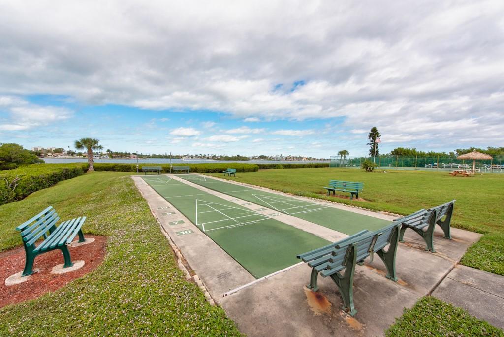 12760 Indian Rocks Road, Unit 601 Largo, FL 33774 - Photo 36 of 47 a view of a swimming pool and lounge chairs