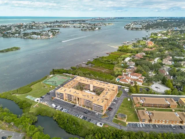 an aerial view of residential houses with outdoor space and river