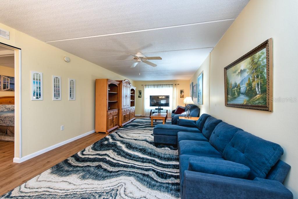 12760 Indian Rocks Road, Unit 601 Largo, FL 33774 - Photo 6 of 47 a living room with furniture ceiling fan and a window