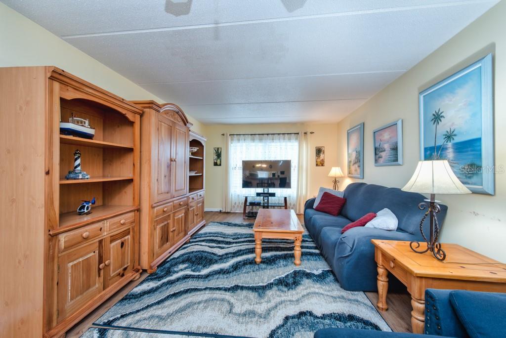 12760 Indian Rocks Road, Unit 601 Largo, FL 33774 - Photo 8 of 47 a living room with furniture a lamp and a window