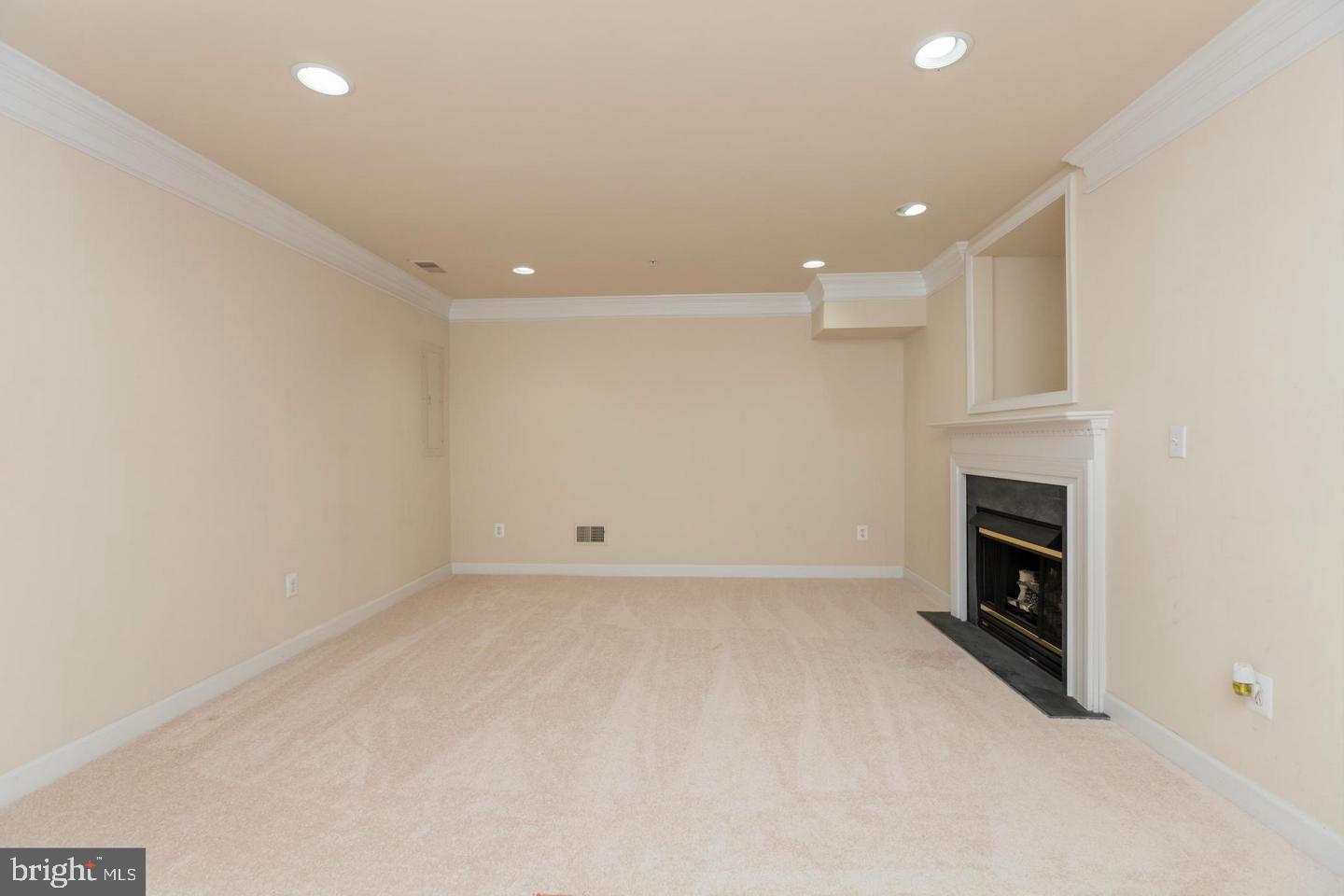 8857 Ashgrove House Lane Vienna, VA 22182 - Photo 25 of 34 Basement with a gas fireplace.