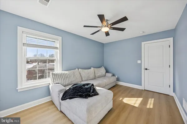 a view of empty room with wooden floor