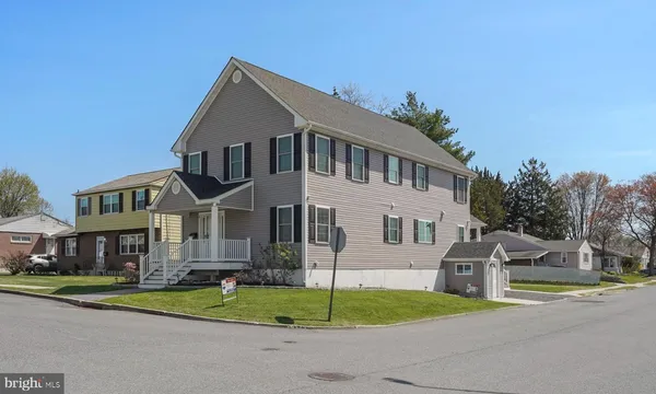 a large kitchen with kitchen island a large window a sink and stainless steel appliances