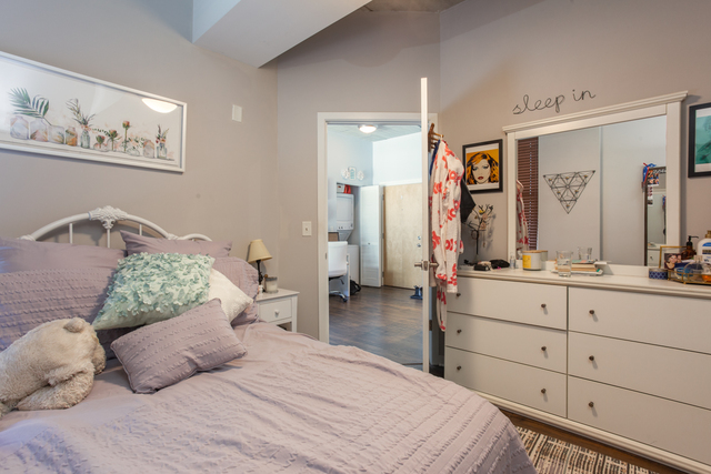 1228 West Monroe Street, Unit 407 Chicago, IL 60607 - Photo 12 of 15 a bedroom with a large bed and a dresser