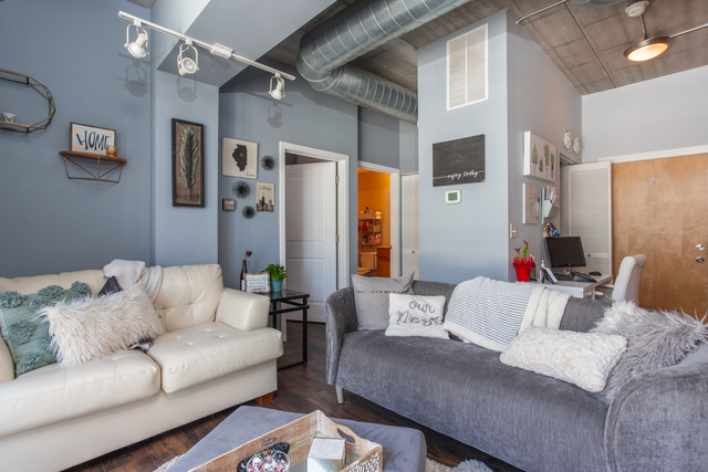 1228 West Monroe Street, Unit 407 Chicago, IL 60607 - Photo 8 of 15 a living room with furniture and a couch