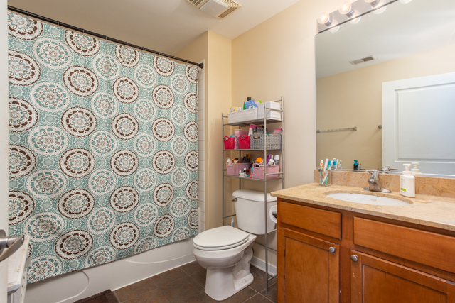 1228 West Monroe Street, Unit 407 Chicago, IL 60607 - Photo 10 of 15 a bathroom with a toilet sink shower and mirror
