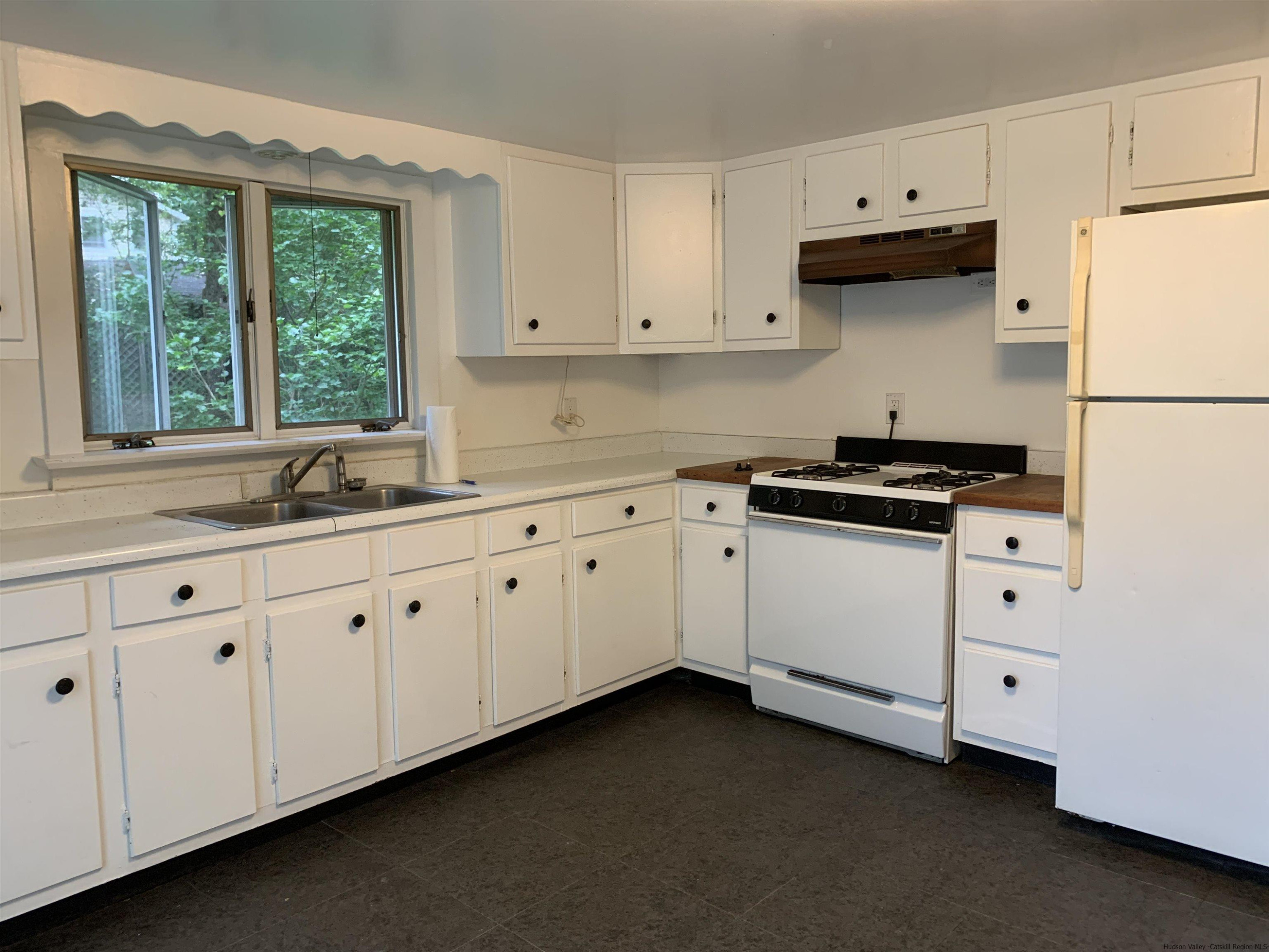 180 Bruceville Road High Falls, NY 12440 - Photo 11 of 22 a kitchen with granite countertop white cabinets white appliances and a wide window