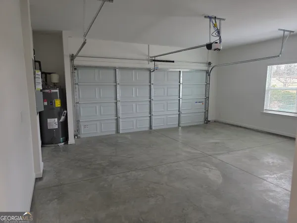 an empty room with closet and windows