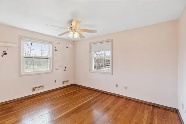 wooden floor in an empty room with a window