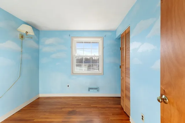 a view of a livingroom with wooden floor and a ceiling fan
