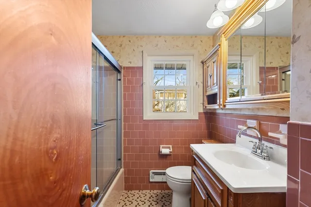 a bathroom with a sink a toilet and shower curtain