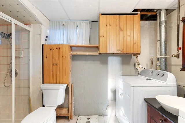 a white toilet sitting next to a bathroom sink