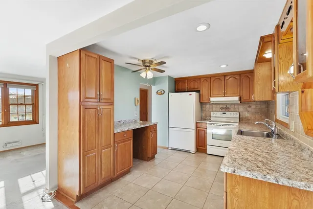 a kitchen with stainless steel appliances granite countertop a refrigerator and a sink