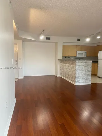 a view of kitchen with cabinets and wooden floor