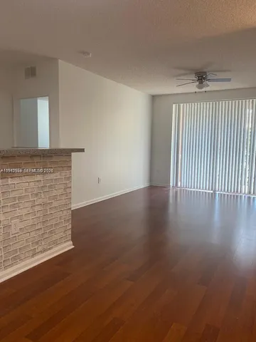 an empty room with wooden floor