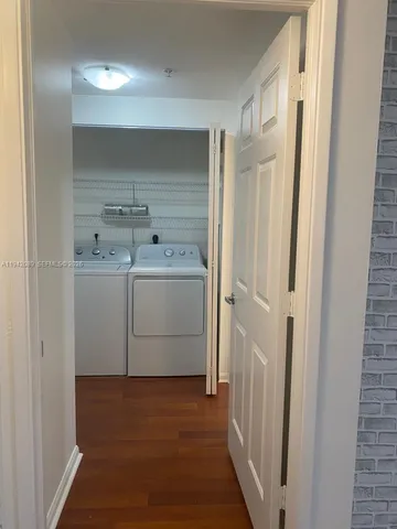 a utility room with cabinets washer and dryer