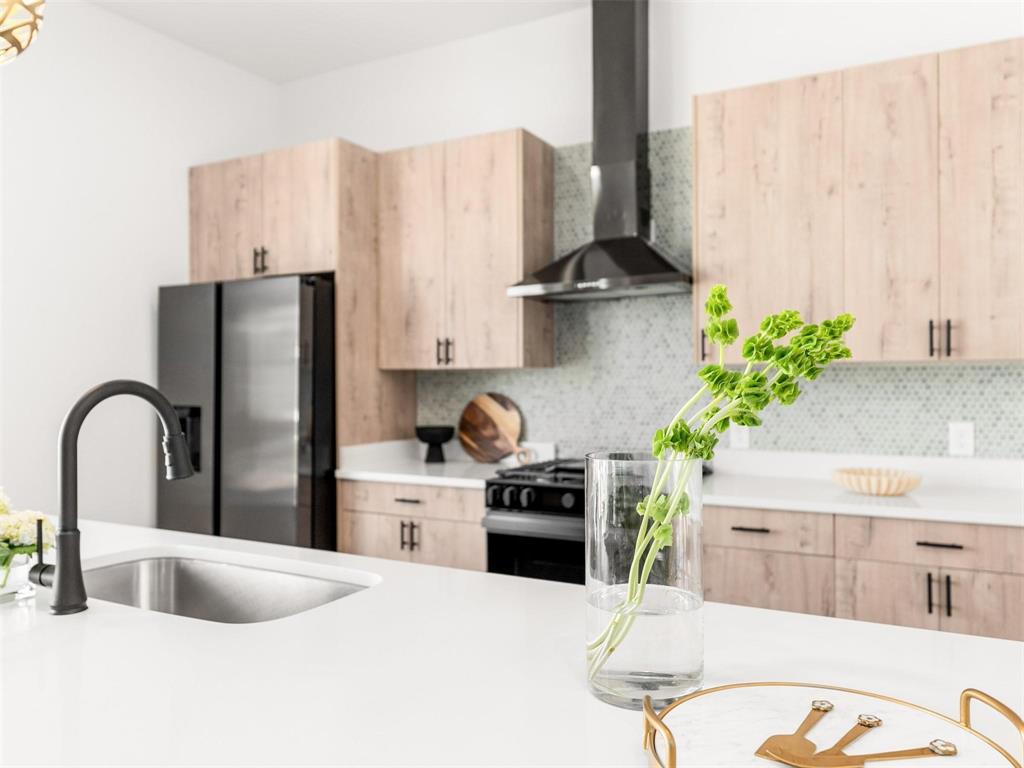 2015 North Prairie Avenue, Unit 207 Dallas, TX 75204 - Photo 1 of 1 a kitchen with stainless steel appliances a sink a counter top space and cabinets