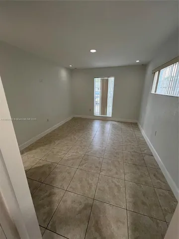 a view of an empty room and a window