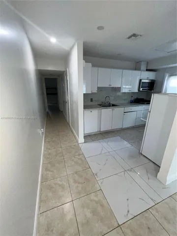 a kitchen with a sink a stove and cabinets