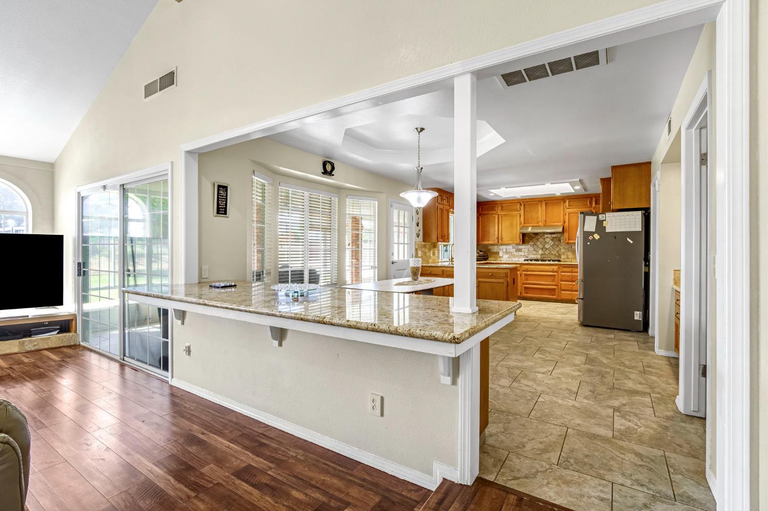 2436 Trevor Court Madera, CA 93637 - Photo 12 of 57 a kitchen with granite countertop a refrigerator and a sink