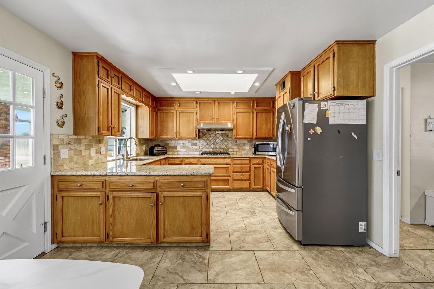 2436 Trevor Court Madera, CA 93637 - Photo 16 of 57 a kitchen with stainless steel appliances granite countertop a refrigerator a stove and a sink