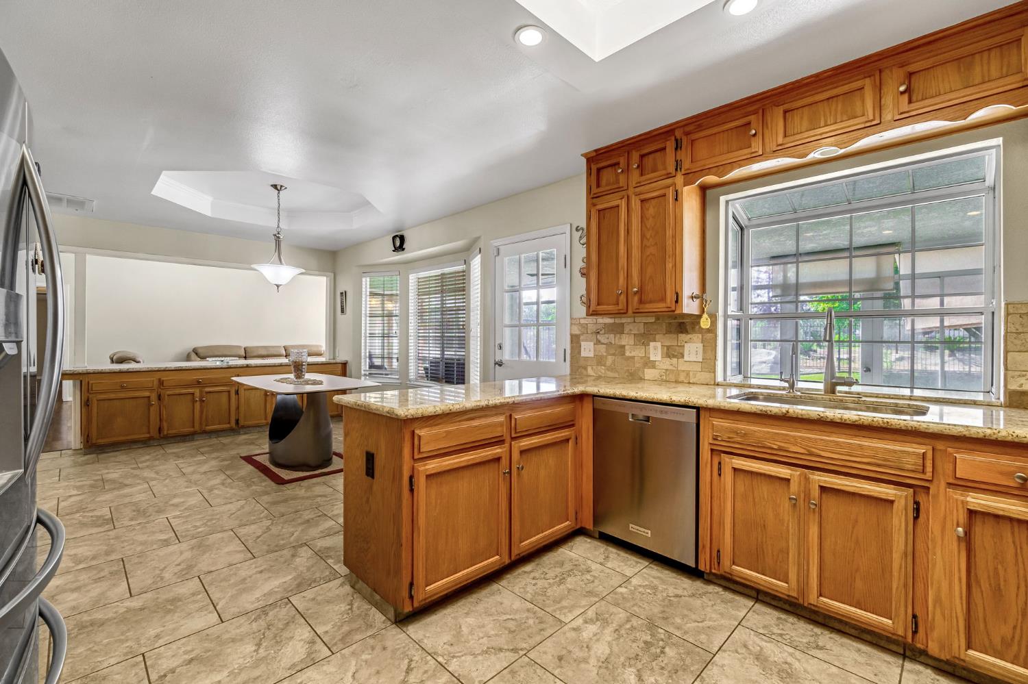 2436 Trevor Court Madera, CA 93637 - Photo 18 of 57 a kitchen with a sink cabinets and window