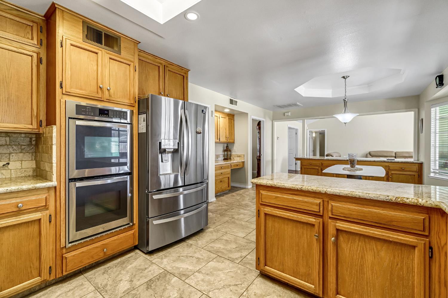 2436 Trevor Court Madera, CA 93637 - Photo 19 of 57 a kitchen with stainless steel appliances granite countertop a refrigerator and a sink