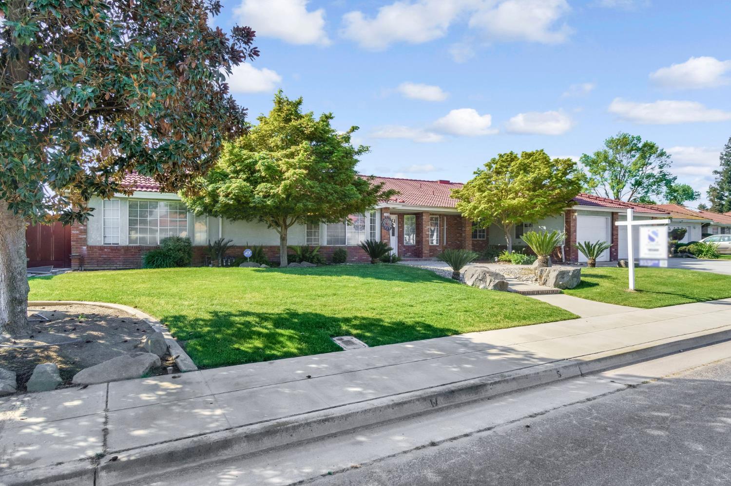 2436 Trevor Court Madera, CA 93637 - Photo 2 of 57 a front view of house with yard and green space
