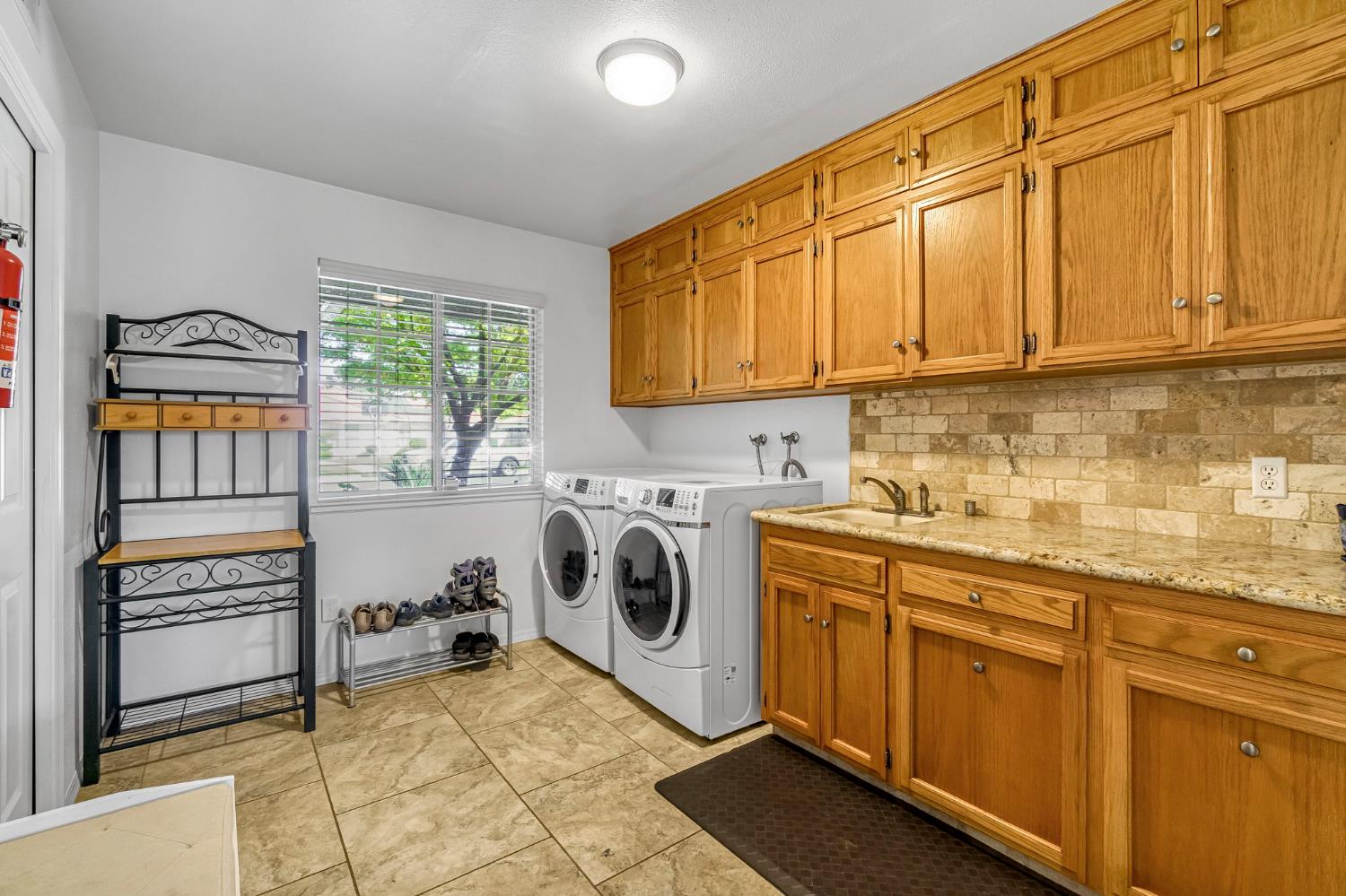 2436 Trevor Court Madera, CA 93637 - Photo 23 of 57 a utility room with sink dryer and washer