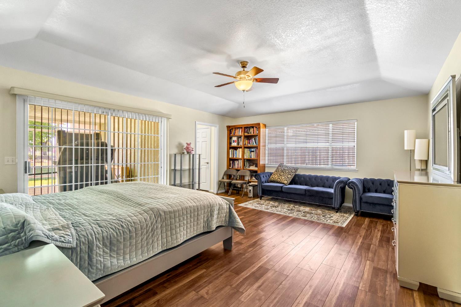 2436 Trevor Court Madera, CA 93637 - Photo 24 of 57 a bedroom with a bed a couch and a large window