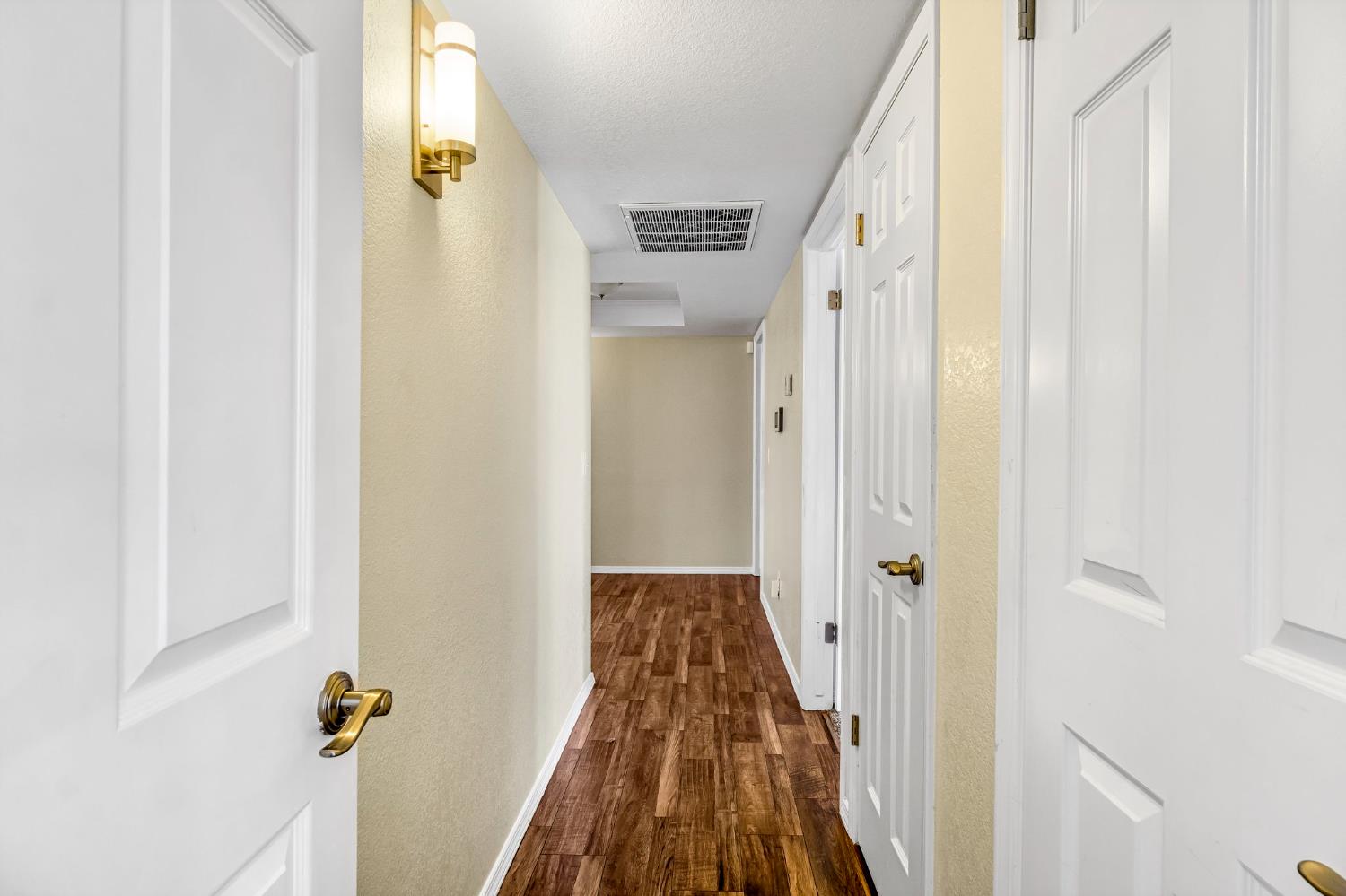 2436 Trevor Court Madera, CA 93637 - Photo 27 of 57 a view of a hallway with wooden floor and staircase