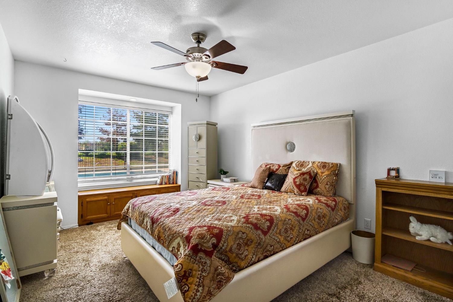 2436 Trevor Court Madera, CA 93637 - Photo 28 of 57 a bedroom with a bed and a chandelier