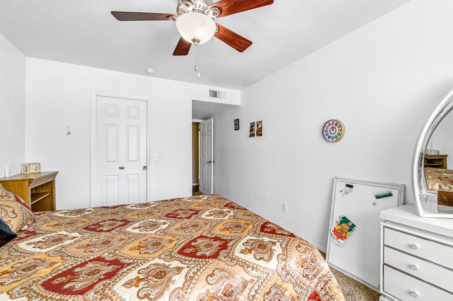 2436 Trevor Court Madera, CA 93637 - Photo 29 of 57 a bedroom with a bed and a chandelier