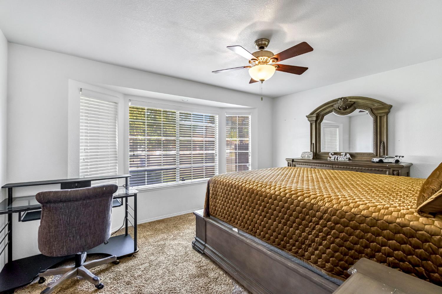 2436 Trevor Court Madera, CA 93637 - Photo 32 of 57 a bedroom with a large bed and a window