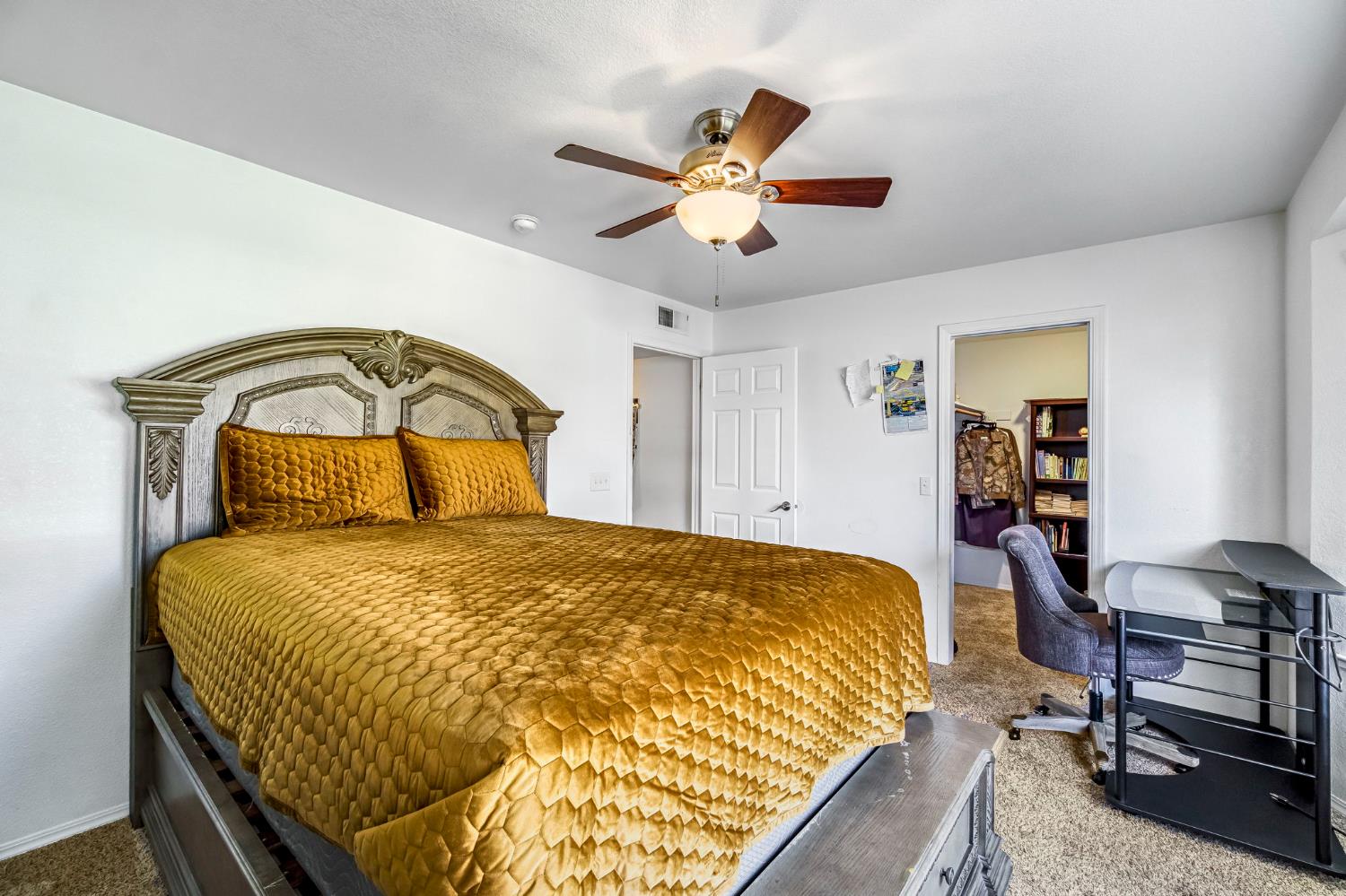 2436 Trevor Court Madera, CA 93637 - Photo 33 of 57 a bedroom with a bed a desk and chair