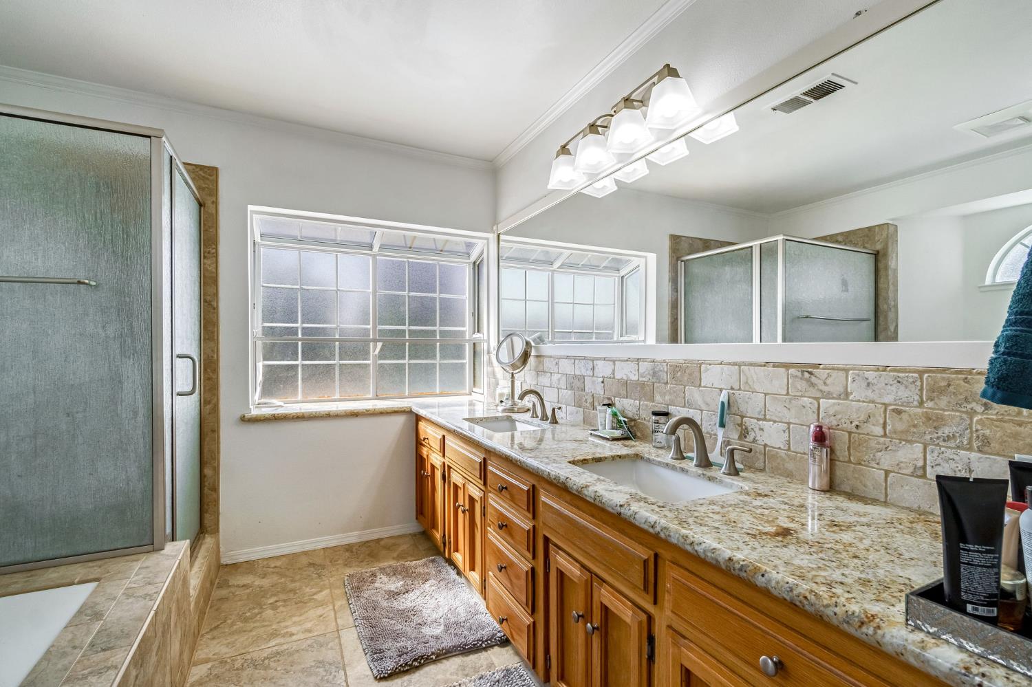 2436 Trevor Court Madera, CA 93637 - Photo 40 of 57 a bathroom with a sink double vanity granite and a mirror