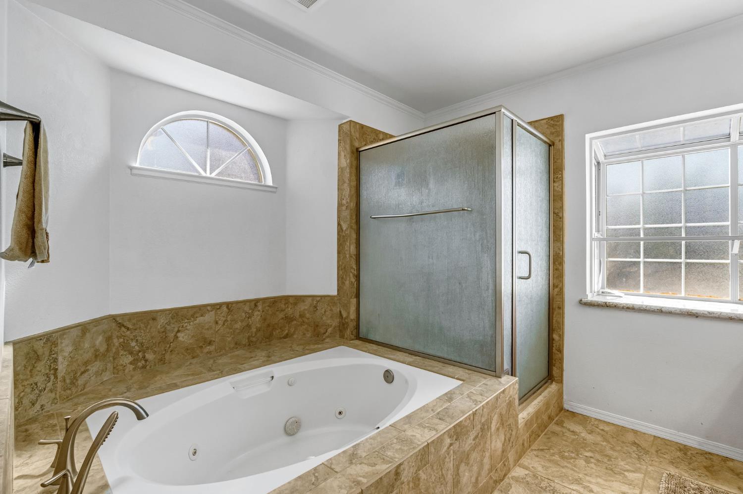 2436 Trevor Court Madera, CA 93637 - Photo 41 of 57 a bathroom with a tub and shower