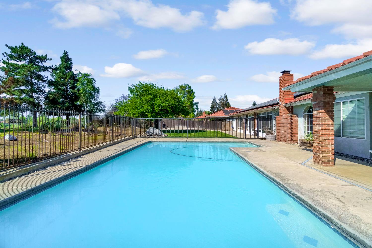 2436 Trevor Court Madera, CA 93637 - Photo 44 of 57 a view of a house with swimming pool and sitting area