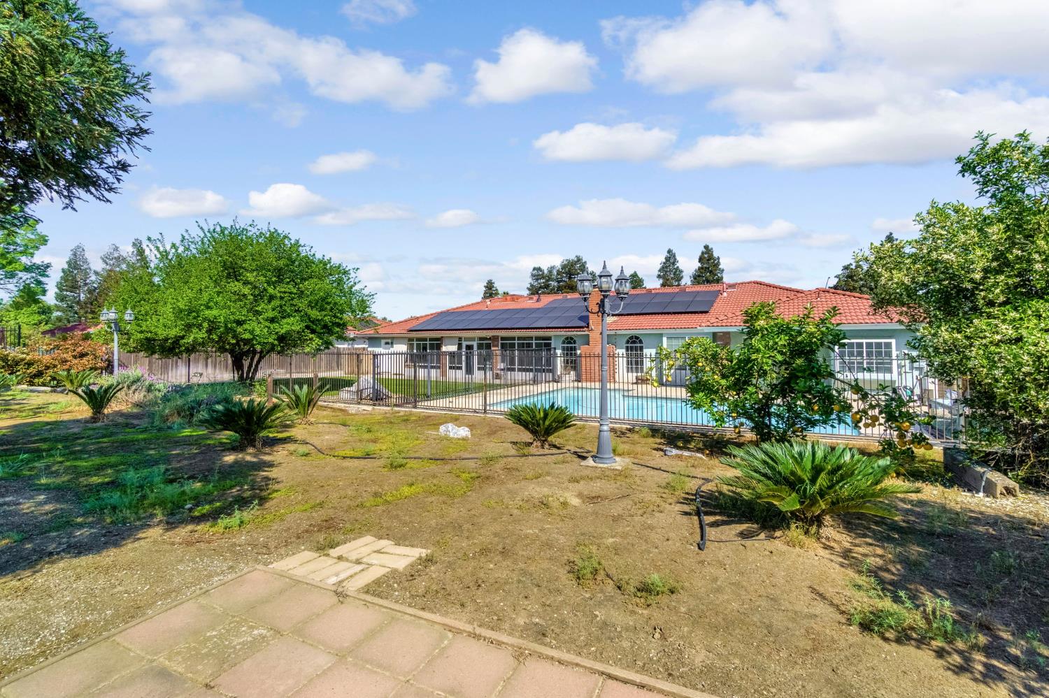 2436 Trevor Court Madera, CA 93637 - Photo 50 of 57 a view of a house with swimming pool and sitting area