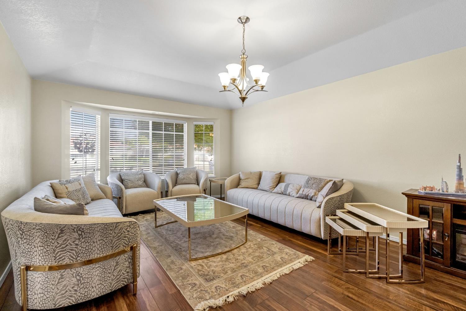 2436 Trevor Court Madera, CA 93637 - Photo 7 of 57 a living room with furniture and a chandelier