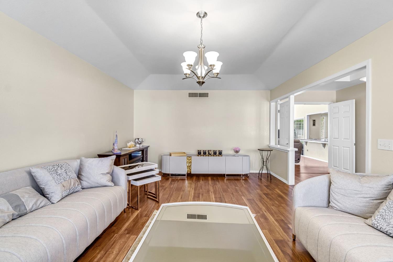 2436 Trevor Court Madera, CA 93637 - Photo 8 of 57 a living room with furniture and a chandelier