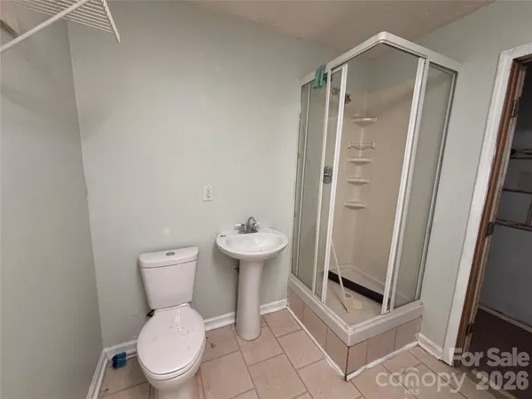 a white toilet sitting next to a bathroom sink